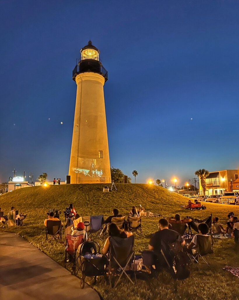 A crowd begins to gather for a Summer Thursday night movie at the Port Isabel Lighthouse.
